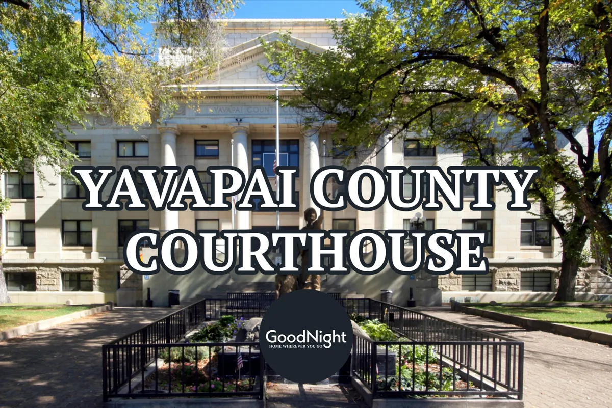 A prominent view of the Yavapai County Courthouse, featuring classic architecture, a statue in the foreground, and landscaped gardens. The courthouse square is a local landmark and frequent site of community events and live music.